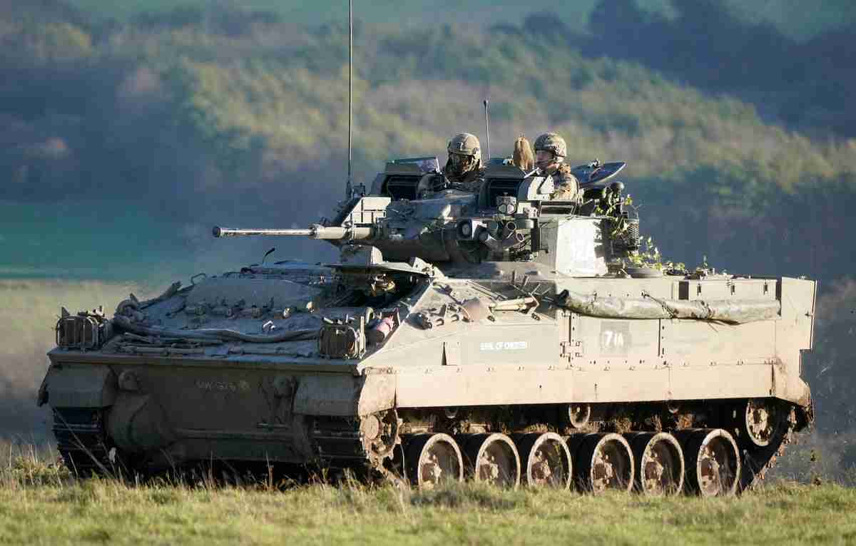 Prince of Wales throws smoke grenades during military mock attack