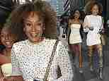 Mel B puts on a leggy display in a white jewelled mini dress and thigh-high leopard print boots for a night out in Manchester with her daughters